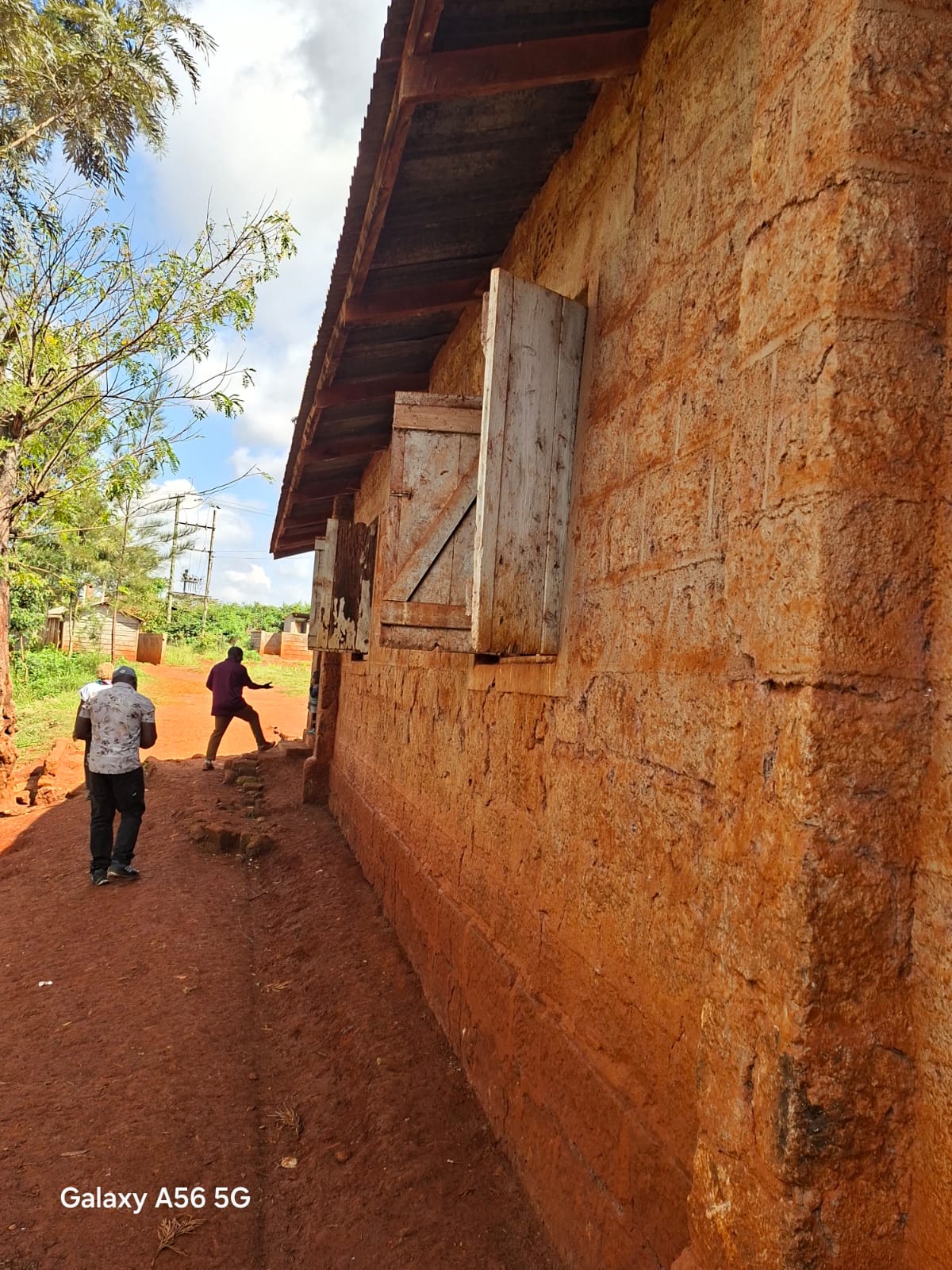 Side wall and windows of a classroom at Karakuta